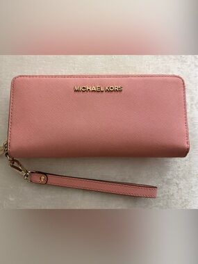 Authentic Michael Kors light to medium pink large clutch wallet.